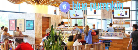 Blue Pumpkin café in a modern airport terminal, showcasing a contemporary foodservice concept with fresh food, coffee and customer seating.