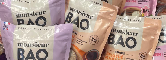 Monsieur Bao frozen bao products displayed in a refrigerated retail cabinet in a European supermarket.